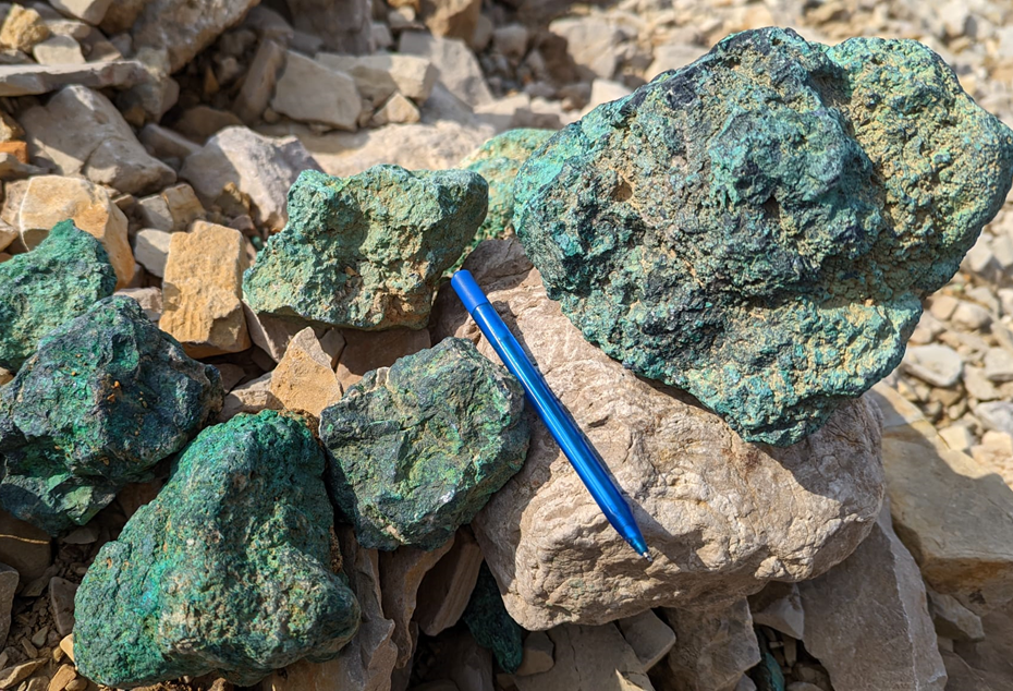 Figure 1: Massive chalcocite boulders exposed in the gully below the Lightning Ridge Prospect. The continued addition of new high-grade copper zones is significantly adding to the camp scale potential of the near-surface mineralization at Storm. The boulders are massive chalcocite (a copper sulfide mineral containing approximately 79.8% Cu with a thin weathering rind of green malachite (copper carbonate)).