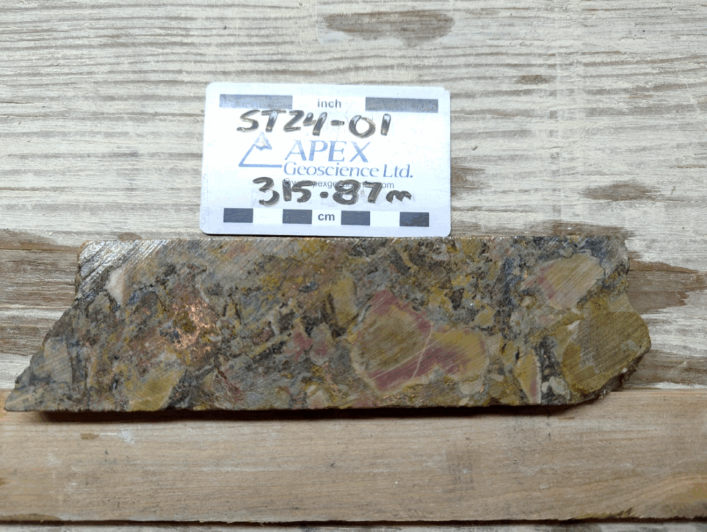 Figure 3: Chalcocite (dark grey) breccia and native copper (metallic) blebs within fractured dolomite in drill hole ST24-01 from approximately 315.87m downhole.